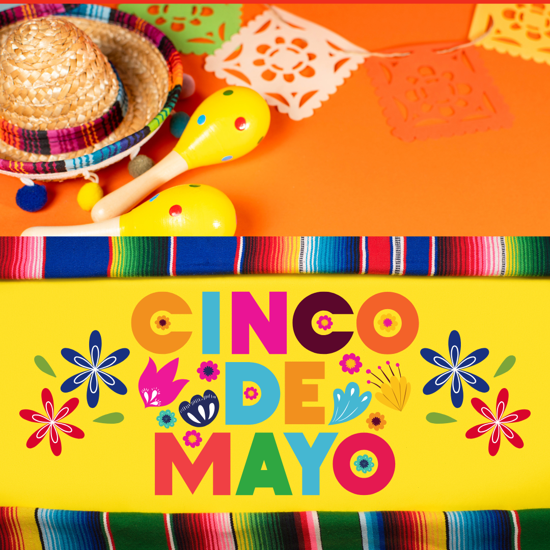 A table with mexican decorations and cinco de mayo sign.